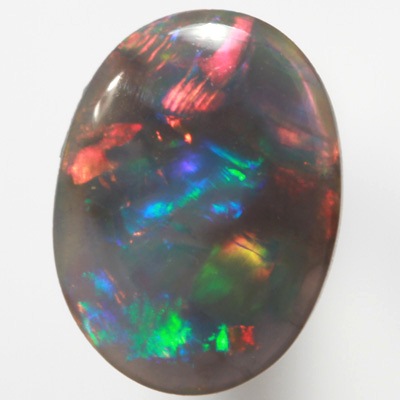 SOLID BLACK OPAL Gemmy fire of red, green and blue SEE VIDEO